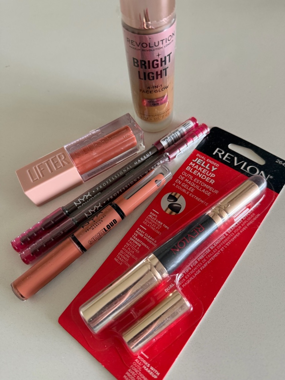 Revlon Bright Light, makeup blender, NYX lifter gloss, gloss, brow pencil
